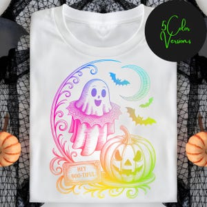 May include: White t-shirt featuring a colorful Halloween design. The graphic includes a ghost, pumpkin, bats, and the phrase "Hey Boo-tiful." The design is outlined in a rainbow gradient, with a black circle that says "5 Color Versions".