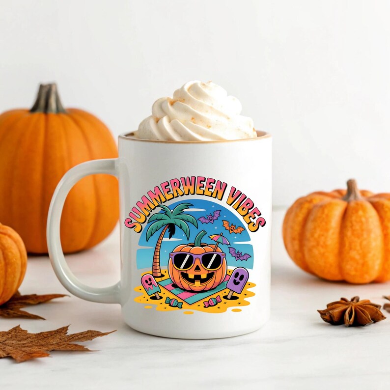 May include: White ceramic mug with the words "Summerween Vibes" and a cartoon pumpkin wearing sunglasses on a beach. The mug is filled with a white whipped topping. Two orange pumpkins are in the background.