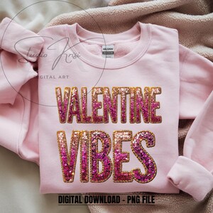 May include: A light pink sweatshirt with the words "VALENTINE VIBES" in sequined letters. The text is in a gradient of pink and gold. The words "DIGITAL DOWNLOAD - PNG FILE" are at the bottom of the sweatshirt.