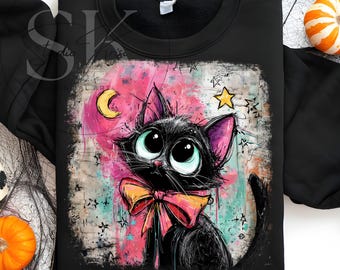 May include: Black sweatshirt featuring a cartoon black cat with large green eyes, a pink bow, and pink-lined ears. The cat is set against a pink and blue background with stars and a crescent moon. The text "DIGITAL DOWNLOAD - PNG FILE" is at the bottom.