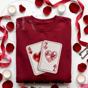 May include: A claret-coloured sweatshirt with two playing cards featuring heart designs. One card shows a six of hearts, the other a seven of hearts. The cards are embellished with rhinestones. The text "DIGITAL DOWNLOAD - PNG FILE" is at the bottom.
