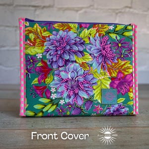 May include: A square pouch with a floral pattern featuring teal, purple, and pink flowers. It has a pink and white striped trim and a teal square patch with text. The words "Front Cover" are at the bottom.