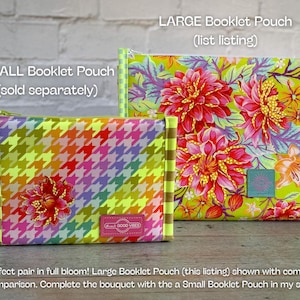 May include: Two fabric pouches. The smaller pouch has a rainbow houndstooth pattern with a floral accent. The larger pouch features a floral design with red and pink flowers on a green background. Text on the pouches reads "SMALL Booklet Pouch" and "LARGE Booklet Pouch".