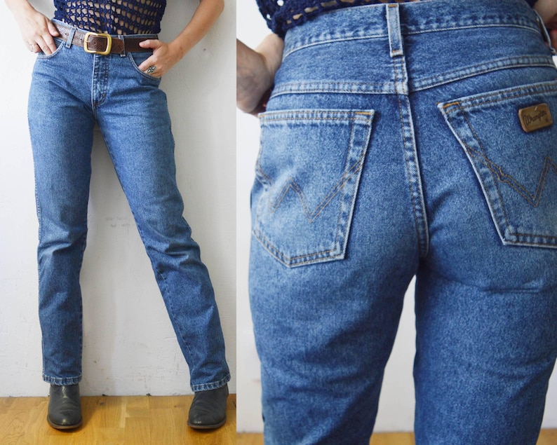 May include: A pair of high-waisted blue denim jeans with a classic straight leg fit. The jeans have a light wash and are made of a soft, comfortable denim.