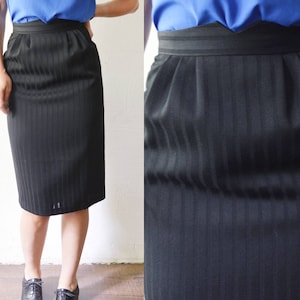 May include: A black skirt with vertical stripes. The skirt is knee-length and has a straight silhouette.