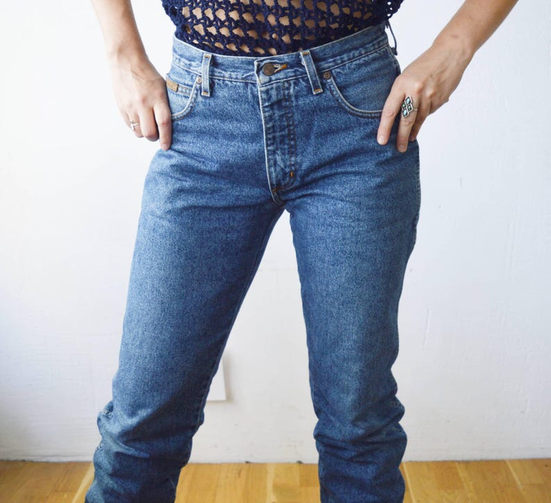 May include: A pair of blue denim jeans with a high waist and a straight leg.