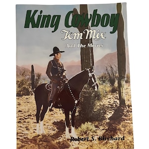 May include: A book cover featuring a cowboy riding a horse in a desert landscape. The title is "King Cowboy Tom Mix And The Movies" with the author's name "Robert S. Birchard" at the bottom.