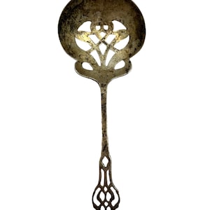 May include: A silver serving spoon with an ornate, openwork design. The spoon has a round bowl with a floral pattern and a long, slender handle.