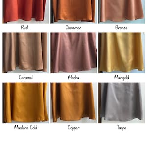 May include: A satin colour chart showing nine fabric swatches in different shades. Colours include rust, cinnamon, bronze, caramel, mocha, marigold, mustard gold, copper, and taupe. The text "Satin Colour Chart" is at the top.