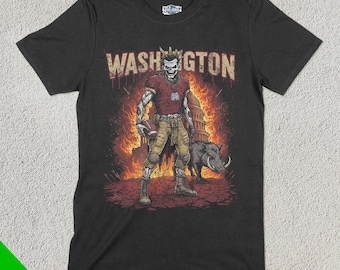 Op de afbeelding: Zwart T-shirt met een afbeelding van een zombie-voetballer die een rood-wit shirt draagt, een voetbal vasthoudt en voor het Amerikaanse Capitool staat. De tekst "WASHINGTON" staat boven de speler.