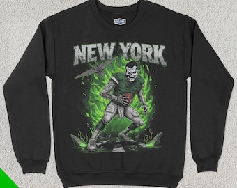 May include: Black sweatshirt with a green and white graphic of a skeleton football player with the text "NEW YORK" on the front.