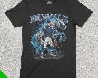 May include: A black t-shirt featuring a graphic of a football player riding a skeletal horse with flames. The text "INDIANAPOLIS" is printed above the graphic.