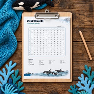 May include: A word search puzzle sheet on a wooden clipboard featuring a grid of letters, a word bank, and illustrations of orcas. The sheet includes the text WORD SEARCH, Can you find all 10 words?, and a list of words including calf, fin, salmon, click, orca, squid, dolphin, echo, and saddle.