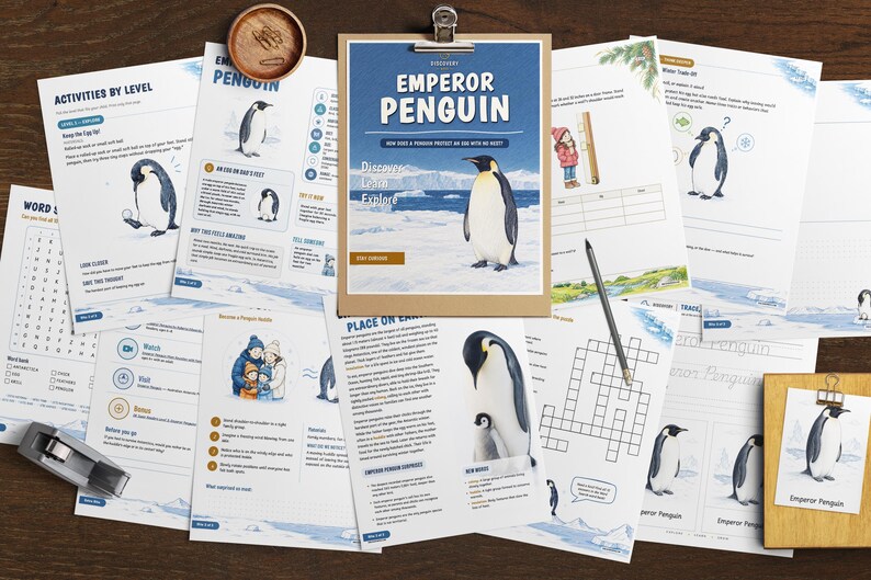 May include: A collection of educational activity sheets about Emperor Penguins, featuring illustrations of penguins in icy habitats, word searches, crossword puzzles, and informational text. A wooden clipboard holds the main cover page.