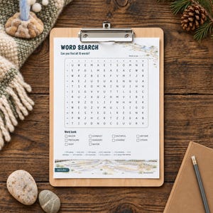 May include: A word search puzzle printed on white paper, secured to a wooden clipboard. The puzzle features a grid of letters, a word bank with terms like basin, pressure, and vent, and a landscape illustration at the top and bottom.