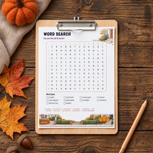 May include: A word search puzzle sheet on a wooden clipboard featuring a grid of letters, a word bank with terms like Candy, Costume, and Pumpkin, and illustrations of autumn scenery. A wooden pencil lies next to the clipboard.