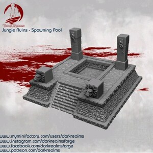 May include: A gray miniature model of a jungle ruin spawning pool. The model features a central sunken area, steps, and decorative pillars with carved animal faces. The text "Dark Realms Jungle Ruins - Spawning Pool" is visible.