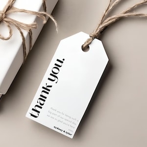 May include: White gift tag with black text that reads "thank you." The text continues with "thank you for being such a big part of our special day. We are so glad you're here. xoxo sydney & tyler"