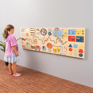 Sensory wall busy board in Scandinavian colors. Nursery or kids room decor. Montessori activity board for toddlers