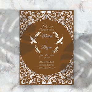 May include: A brown wedding invitation with white floral designs. The invitation reads "Join us to celebrate the union of Mariah + Bryan June 20, 2026 at five o'clock El Sabino Wine Resort Escondido, California Celebration To Be Announced"