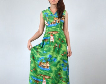 May include: A sleeveless, floor-length green dress with a tropical print featuring huts, palm trees, and sailboats. The dress has a ruffled neckline and a flowing silhouette, perfect for a summer day.