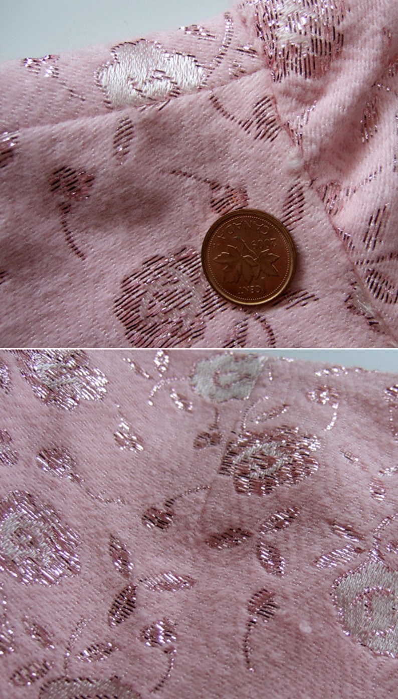 May include: Close-up of pink fabric with a floral pattern. The fabric has a textured appearance with silver metallic accents. A Canadian one-cent coin is placed on the fabric for scale.