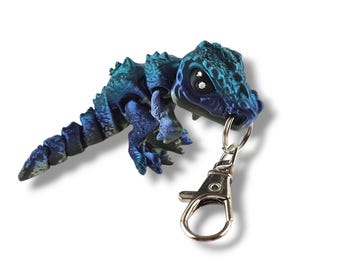 Divertido llavero vibrante de T-Rex, exclusivo y atractivo juguete antiestrés, dinosaurio coleccionable que llama la atención