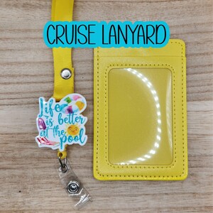 May include: Yellow cruise lanyard with a matching ID holder. The lanyard has a badge reel with a colorful graphic that says "Life is better at the pool". The text "CRUISE LANYARD" is in a blue bubble.