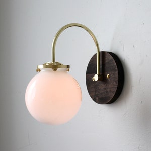 Globe Sconce Lamp, Curved Brass Arm, Wood Base, White Glass Shade, Mid Century Modern Wall Mounted Lighting Fixture, Wire-In Or Plug-In
