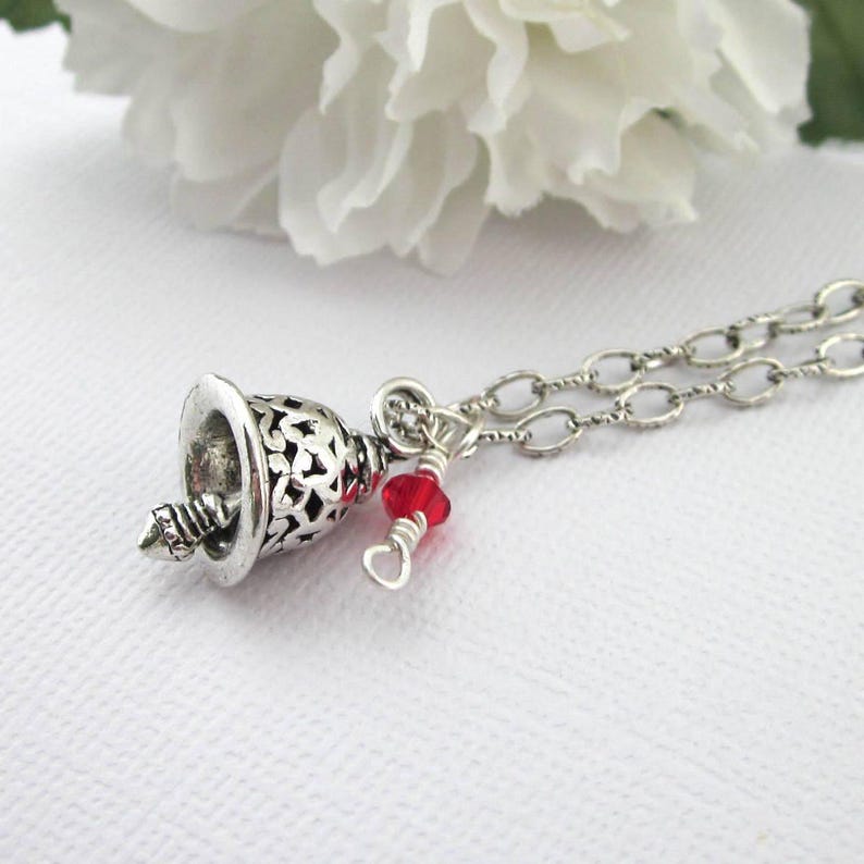 Silver plated filigree bell charm necklace with a small 4 mm red Swarovski crystal.  Choose silver plated chain length 16 thru 19 inches.  Organza gift pouch included.