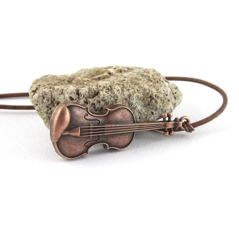 Large antiqued copper violin pendant with fine leather cord. Choose 24 or 26 inches cord length. Violin is 55 mm x 16 mm - 2 1/8 inches x 7/8 inch. Organza gift pouch included. Great gift for female or male violinist.