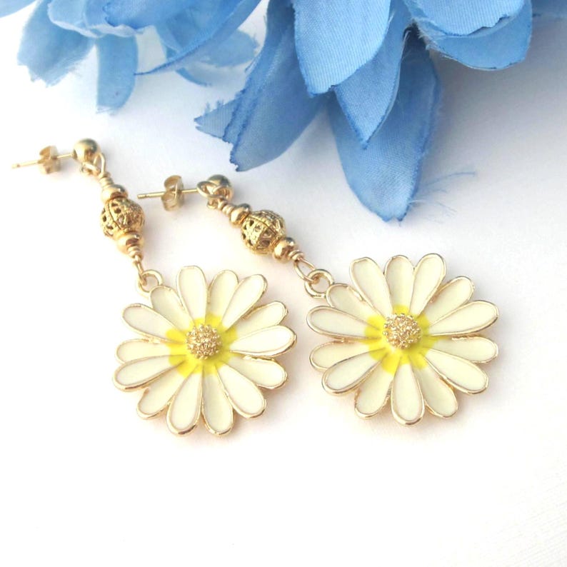 Cream, yellow and gold large daisy flower earrings. The flowers dangle from gold plated filigree beads and 22k gold filled Heishi rondells. Earrings dangle approximately 2 1/8 inch long.  Flower charms are 25mm x 28 mm including the top loop.  Organza gift pouch is included.