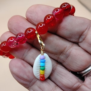 Rainbow Cowrie Shell Bracelet with red gemstone beads.