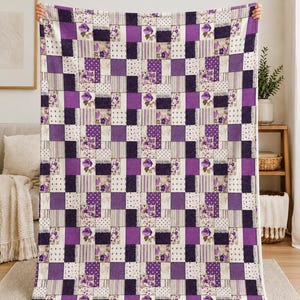 May include: A rectangular throw blanket featuring a patchwork design of alternating squares in shades of purple, white, and cream. The pattern includes floral rose prints, vertical stripes, and polka dots, arranged in a grid across the fabric.