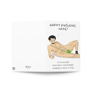 May include: A folded white greeting card with the text "HAPPY BIRTHDAY, NAME!" and a cartoon illustration of a man in a green thong. The text below reads "IN MY COUNTRY, YOUR AGE IS CONSIDERED POWERFUL & SEXY! IS NICE!"