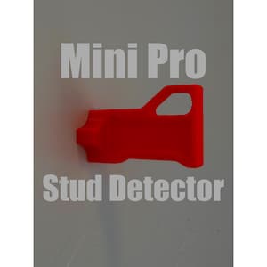 Könnte beinhalten: Ein leuchtend roter Ständerdetektor mit dem Text "Mini Pro" und "Stud Detector" in Weiß. Das Werkzeug hat ein griffartiges Design und wird wahrscheinlich zum Auffinden von Ständern in Wänden verwendet. Der Hintergrund ist hellgrau.