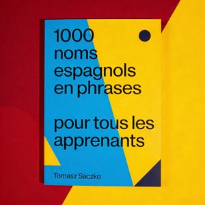 May include: A book titled "1000 noms espagnols en phrases pour tous les apprenants" by Tomasz Saczko. The cover features a blue and yellow geometric design with black text. A small black circle is in the upper right corner.