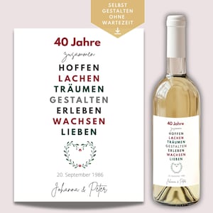 Puede incluir: Una botella de vino blanco con una etiqueta que dice "40 Jahre" y una lista de palabras. Junto a ella hay una impresión a juego con el mismo texto y un diseño de corazón floral. La impresión también incluye la fecha "20. September 1986".