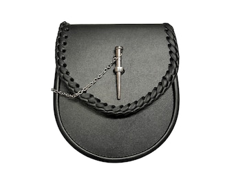 May include: A black leather sporran with a braided strap and a silver chain and a silver dagger-shaped pin.