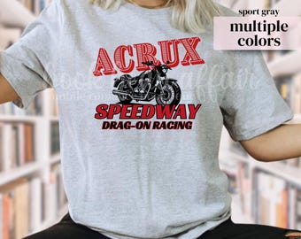 May include: Sport gray t-shirt with a motorcycle graphic. The design features the word "ACRUX" in red, above a black motorcycle illustration, and "SPEEDWAY DRAG-ON RACING" in red. The shirt is available in multiple colors.