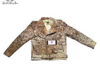 May include: A brown and white cowhide leather jacket with a zipper closure and a belt. The jacket has a  "LeatherStoreAus" logo on the left side of the chest.