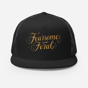 May include: Black trucker hat with the words "Fearsome and Feral" in gold script. The hat has a mesh back and a curved brim. The text is in a decorative font.
