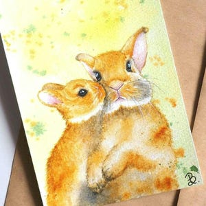 Carte de voeux peinte à la main aquarelle de lapins de Pâques
