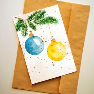 Aquarelle originale peinte à la main avec des boules bleues et jaunes, une carte de Noël, une carte de joyeux Noël, une carte faite main Feliz Navidad