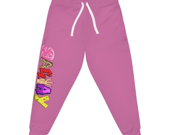 May include: Pink sweatpants with a white drawstring. The left leg features the word "KATE" in colorful graffiti-style lettering. The letters have leopard print, red, peace sign, purple, and yellow cheese designs.
