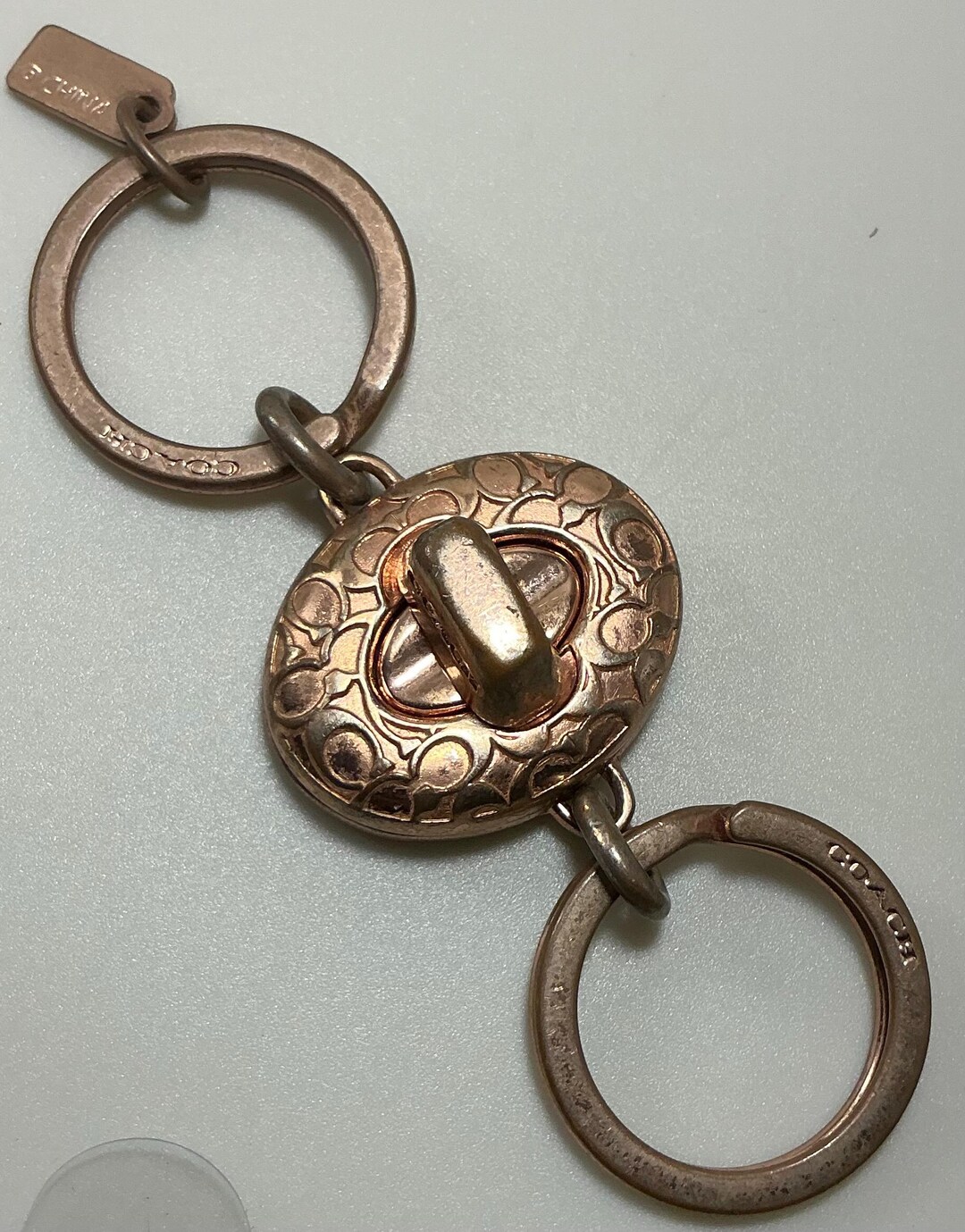 A Rare Vintage Y2K Coach Rose Gold Sig Turnlock Valet Keychain