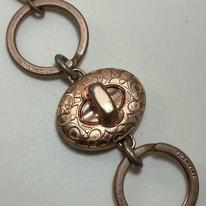 A Rare Vintage Y2K Coach Rose Gold Sig Turnlock Valet Keychain