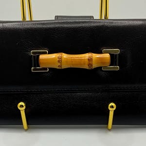 Uma carteira de couro Gucci Dark Blown Bamboo Snap muito rara