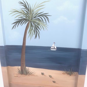 May include: A hand-painted wooden panel depicting a beach scene. The panel features a palm tree, a sailboat on the ocean, and sea turtles on the sand.