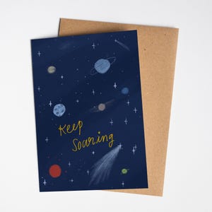Tarjeta de felicitación con el mensaje Keep Soaring / Space